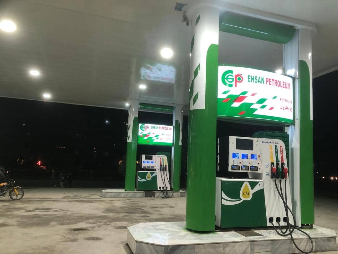 Ehsan Petroleum fuel station canopy with illuminated dispensers at night